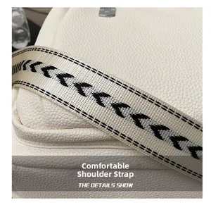 Macro detail of high-quality white lychee texture leather backpack with a geometric strap