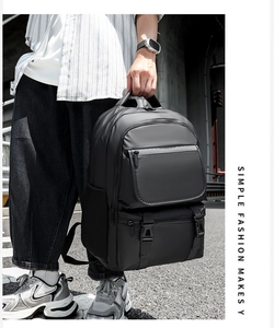 Detail of black water-resistant nylon backpack with multi-layer zipper compartments