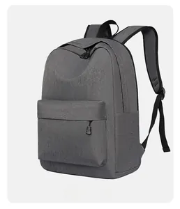 Detail view of large Oxford cloth backpack featuring dark gray texture and front pocket