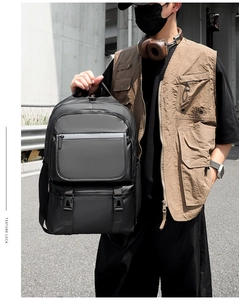 Men's black tactical nylon backpack featuring front zip pockets and side mesh holder