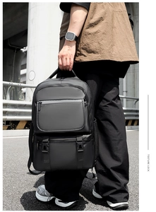 Close-up of durable black techwear backpack with side mesh pocket and buckle detail