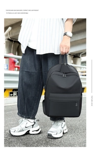 Detail of a lightweight black Oxford cloth backpack with multi-layer zippers for travel