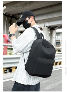 Close-up of black water-resistant oxford backpack with wide adjustable shoulder straps