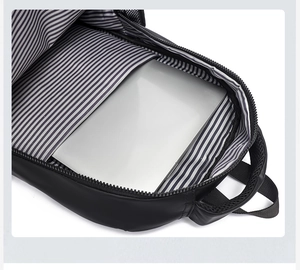 Interior detail of black backpack with striped lining and laptop storage compartment