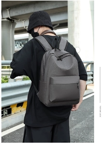 Detail of dark grey Oxford fabric backpack featuring texture lock and durable zippers
