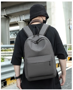Detail of grey oxford fabric backpack with waterproof texture and reinforced shoulder straps