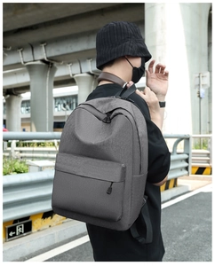 Close-up of grey waterproof oxford fabric texture and front zipper on a casual backpack