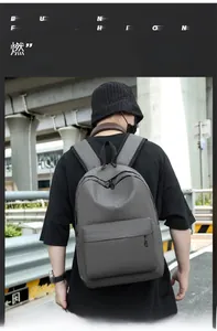 Outdoor shot of a grey minimalist large capacity Oxford fabric travel backpack for students