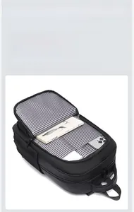 Detailed interior of black travel backpack with striped lining and multiple storage pockets