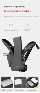 Detail view of large grey oxford backpack showing interior laptop compartment and pockets