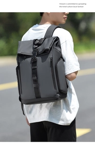 Outdoor view of dark gray waterproof travel backpack with adjustable buckle closure