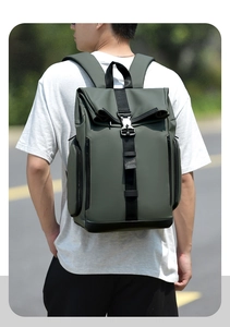 Detail of olive green roll-top backpack showing waterproof fabric and metal buckle closure