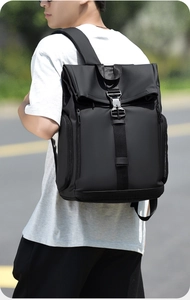 Detail of water-resistant black backpack with metal buckle and padded shoulder straps
