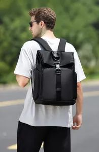 Detail of black travel backpack showing buckle closure and adjustable padded straps