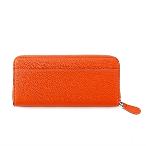Macro detail of orange pebble grain leather wallet with a secure metal zipper closure
