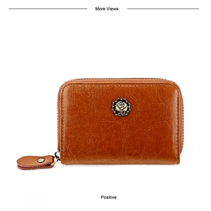 Close-up of brown leather wallet featuring a vintage metal rose emblem and zipper pull