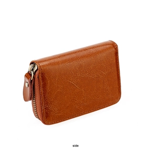 Side view of brown leather card holder with textured surface and metal zipper closure