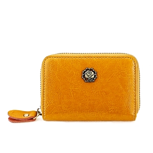 Detail of ginger yellow leather wallet featuring vintage metal rose logo and zipper