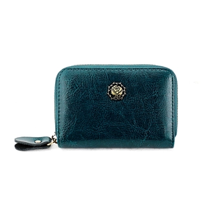 Macro shot of dark green leather card wallet with a vintage gold rose metal emblem