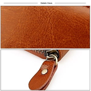 Close-up of brown leather texture and durable metal zipper on a large capacity card holder