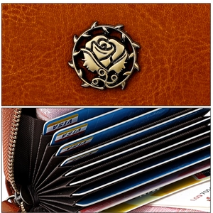 Detailed view of vintage brown leather wallet with rose logo and accordion card slots