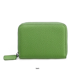 Detail of green leather wallet showing fine litchi texture and smooth zipper on back view