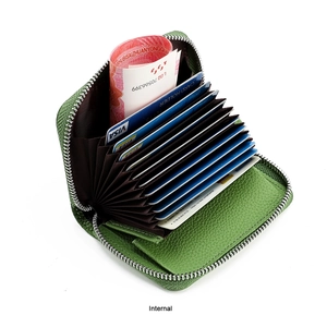 Macro view of the internal accordion card slots and lining of the green leather purse