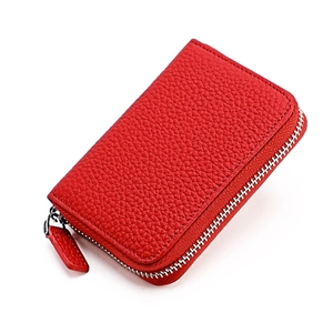 Close-up of red pebbled leather purse with durable silver zipper and textured finish