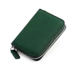Macro shot of dark green litchi texture leather card wallet with silver zip closure