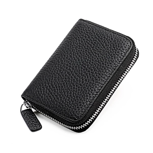 Detail of black litchi leather wallet with wrap-around silver metal zipper closure