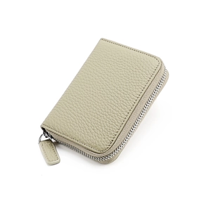 Detailed close-up of light khaki pebble grain leather wallet with a smooth metal zipper