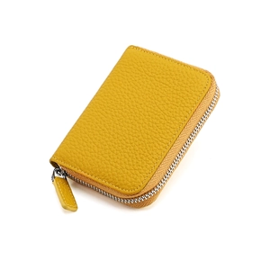 Detail view of ginger yellow lychee pattern leather card purse with silver zipper