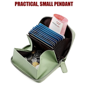 Detail view of a green pebble leather accordion wallet with card slots and coin pocket