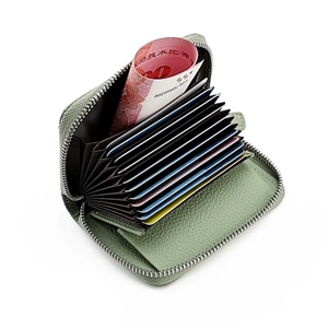 Detailed interior of sage green lychee leather card holder with 11 accordion slots