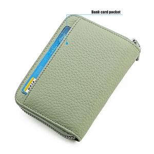 Close-up of light green lychee leather card holder with visa card slot and metal zipper