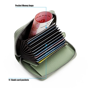 Detail view of leather card holder with 11 slots and a coin pocket in sage green