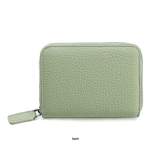 Detail view of the back of a green lychee pattern leather wallet with a metal zipper