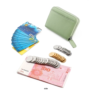 Side view of mint green leather card holder with coins and cash to show high capacity