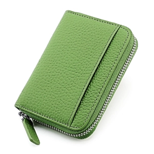 Macro view of green lychee grain leather wallet with silver zipper and external card slot
