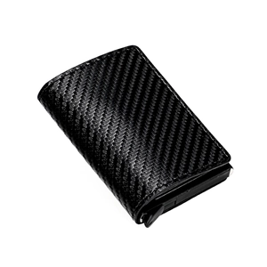 Close-up of black carbon fiber texture on compact aluminum credit card holder wallet
