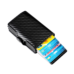 Detail of black carbon fiber automatic pop-up wallet with RFID blocking card mechanism
