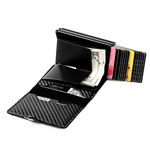 Detail of black carbon fiber RFID card holder showing the automatic pop-up mechanism