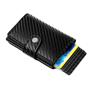 Detail view of carbon fiber RFID card holder with pop-up mechanism and button closure