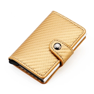 Detail of champagne gold RFID wallet with woven leather texture and pop-up button