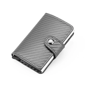 Detail view of carbon fiber texture and RFID blocking aluminum card slot with snap closure