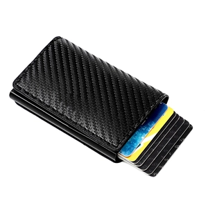 Detail view of carbon fiber card holder with cards popping out of the metal case