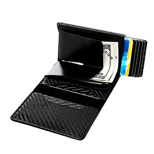 Macro detail of men's slim carbon fiber wallet with metal money clip and pop-up card holder