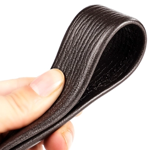 Macro shot of flexible dark brown pebble grain genuine leather belt with natural texture