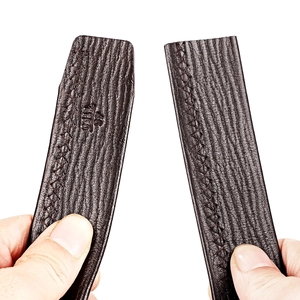 Detail of dark brown leather belt featuring lychee texture and X-shaped cross stitching