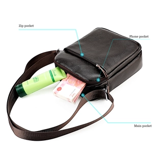 Detail view of leather crossbody bag capacity with zip pockets and interior compartments